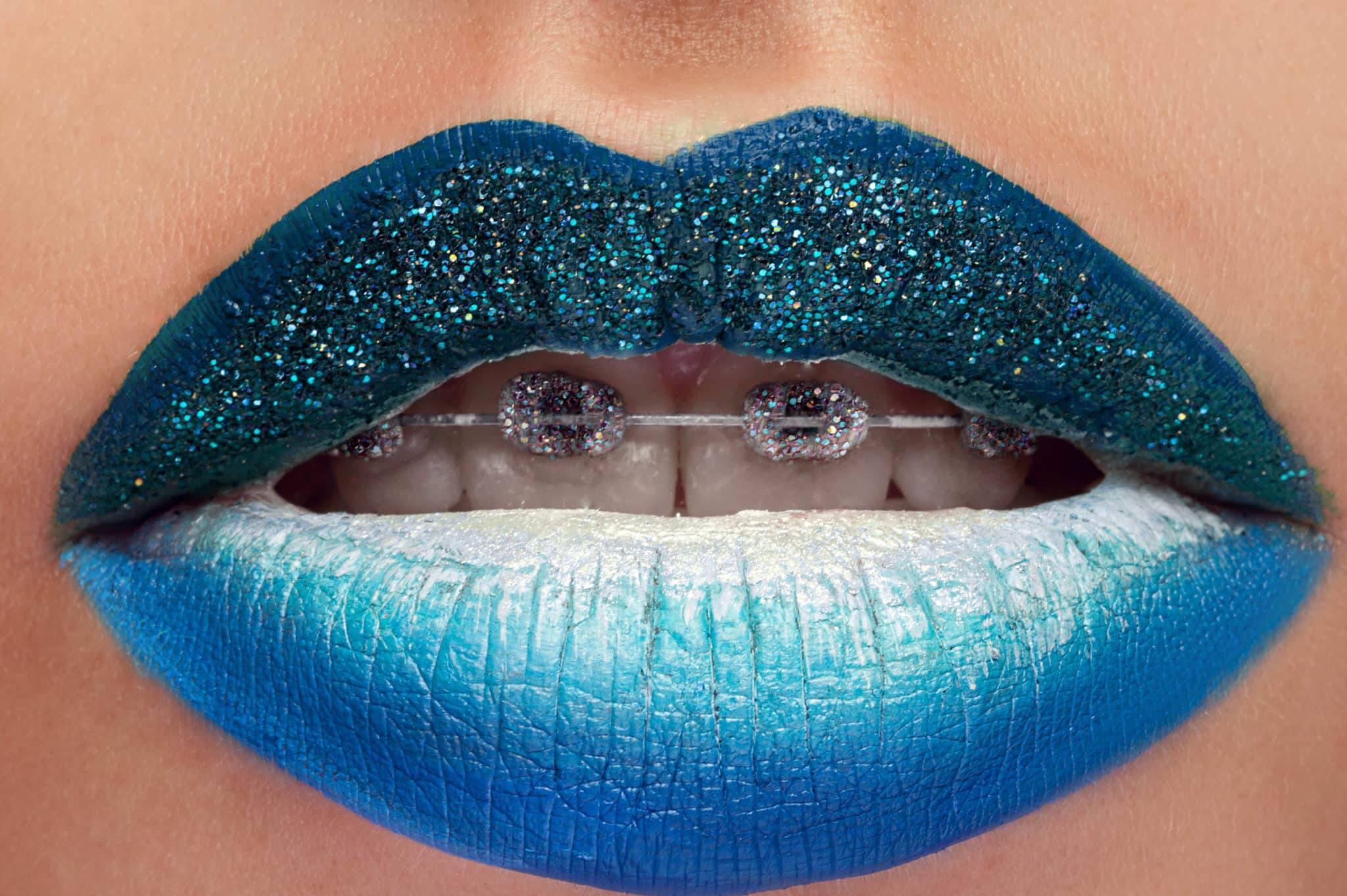 Blue lipstick. Studio close up of a woman wearing blue lipstick posing seductively with her mouth open sexuality unusual creative artistic makeup lip gloss cosmetics art creativity sexy face concept