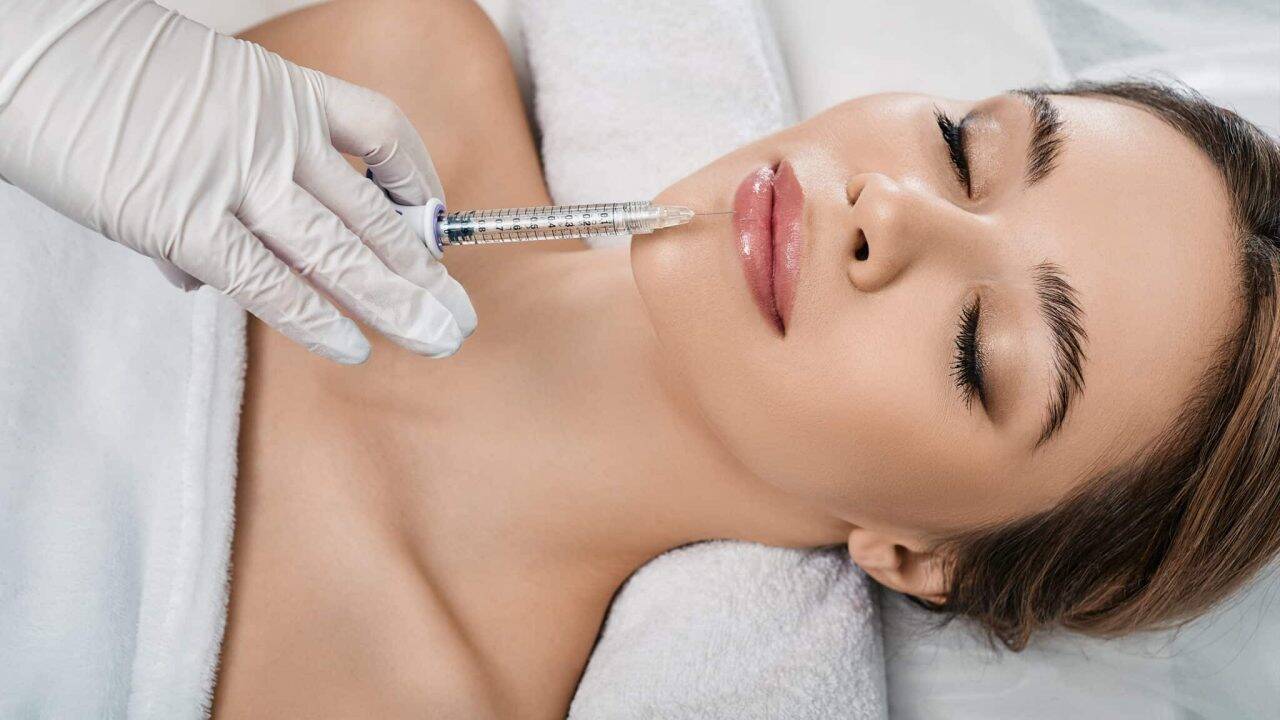woman receives lip fillers